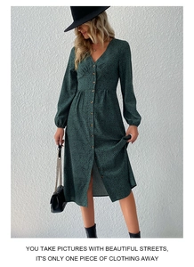 Detailed view of dark green floral midi dress with V-neckline and front buttons