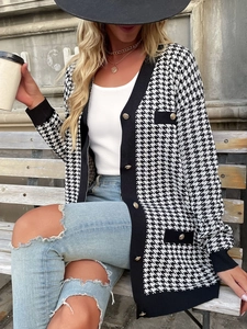Detailed view of houndstooth knit cardigan featuring embossed lion head golden buttons