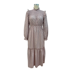 Detail of mock neck dress with polka dot pattern, ruffle hem and elastic waist