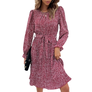 Deep red long sleeve pleated dress with white polka dots and adjustable waist belt