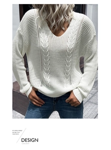 Detail of white V-neck sweater featuring intricate cable knit and hollow-out mesh patterns