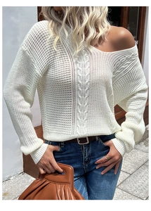 Detailed close-up of white cable knit hollow sweater with off-shoulder neckline and texture