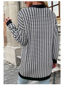 Back view of a long houndstooth knit cardigan with black ribbed cuffs and hem details