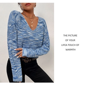 Detail of V-neck space-dye knit sweater in blue and white with textured short crop design