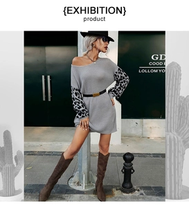 Detail of grey knitted sweater dress featuring leopard print sleeves and off-shoulder neck