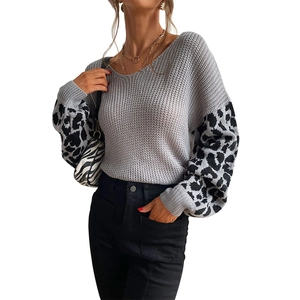 Women's grey knit sweater featuring leopard print puff sleeves and a classic V-neckline