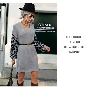 Detailed close-up of grey knit dress with leopard print sleeves and V-neckline texture