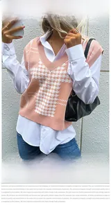 Detail of pink and white houndstooth knit vest paired with a white shirt and blue jeans