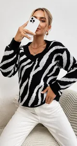 Close-up detail of the black and white zebra pattern on V-neck knit long sleeve sweater
