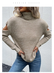 Detail showing high turtleneck design and cold-shoulder cut on beige knit sweater