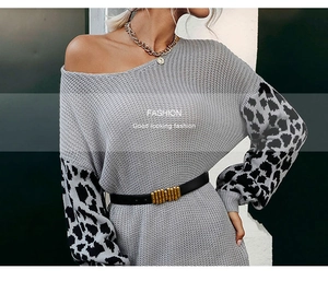 Detail of grey knit dress with leopard print lantern sleeves and a slim black belt