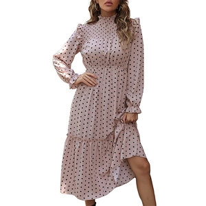 Elegant pink polka dot tiered maxi dress with long sleeves and smocked waist design