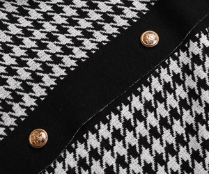 Macro shot of houndstooth knit fabric with vintage embossed gold metal buttons