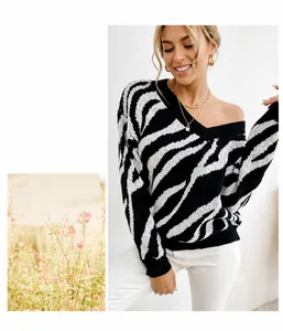Detail shot of oversized zebra print knit sweater with ribbed V-neckline and black cuffs