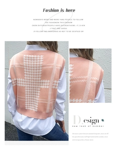 Detail of pink houndstooth knit vest styled over a white shirt for a layered chic look