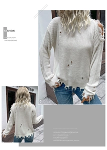Detail of white distressed knit sweater featuring ripped edges and frayed hollow textures