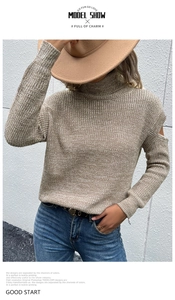 Detail of cut-out shoulder knit sweater in khaki with high neck and textured weave