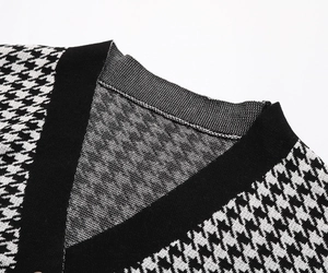 Detail of V-neckline on houndstooth knit cardigan with black ribbed knit texture