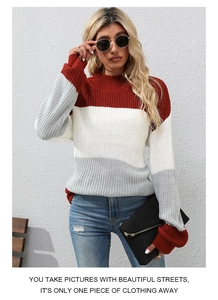 Close-up of color-block knit sweater featuring ribbed turtleneck and tricolor panels