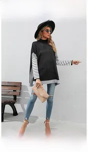 Detail of loose-fit color-block knit sweater with striped sleeves and oversized hem