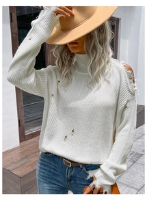 Detailed view of white turtleneck sweater featuring distressed knit and hollow-out design