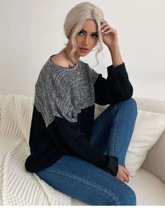 Detail of loose-fit color-block knit sweater with black and white knit pattern