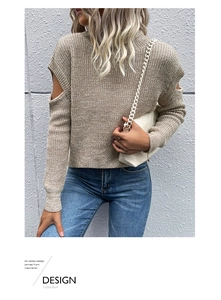 Detail of cut-out shoulder design and chunky knit texture on this high-neck beige sweater