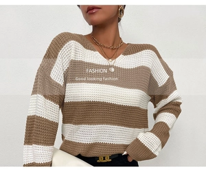 Détail d'un pull en maille à col en V avec des rayures horizontales marron et blanches