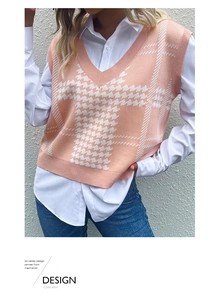 Close-up of pink and white houndstooth knit vest featuring V-neck and textured fabric