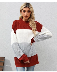 Detail of color-block knit sweater featuring red, white, and gray striped textures