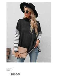 Detail of high neck black sweater featuring black and white striped batwing sleeves