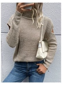 Detail view of stylish cutout shoulder and high collar design on beige knit sweater