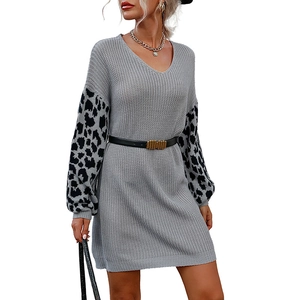Women's light gray knit dress with leopard print sleeves and a stylish black waist belt