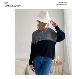Close-up detail of a women's two-tone knit sweater with gray and black contrast paneling