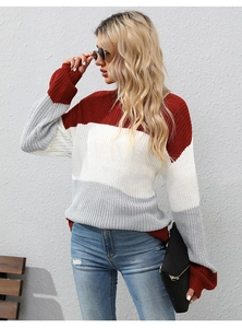 Detail of red, white, and grey color-block knit sweater with coarse textured fabric