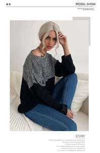 Detail of color-block knit sweater with grey marl top and black ribbed bottom hem