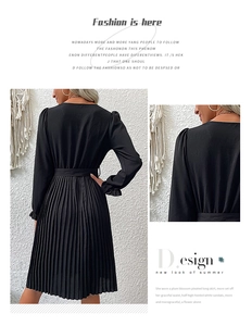 Detail of long sleeve black pleated dress showing waist cut and fine pleats texture