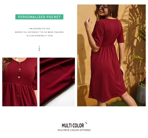Detail view of burgundy V-neck dress featuring functional side pockets and button accents