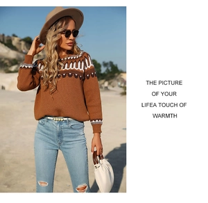 Close-up of brown knit sweater featuring geometric ethnic patterns on collar and cuffs