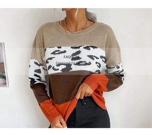 Detail shot of leopard print patchwork knit sweater with vibrant orange cuffs and hem