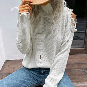 Oversized white turtleneck sweater with distressed cutout details and street style design