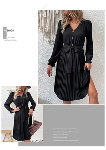 Detail of black pleated long sleeve dress with V-neck, button front, and waist tie belt