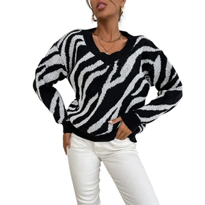 Women's V-neck zebra print knit sweater with long sleeves and black ribbed cuffs