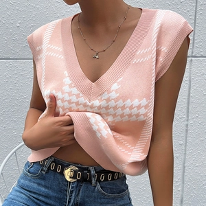 Pink and white houndstooth knitted V-neck sweater vest for women in a stylish outfit