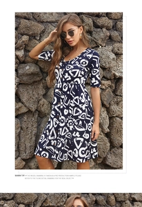 Detailed close-up of V-neckline and button-down front on blue printed holiday dress