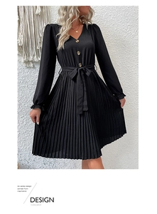 Detail of V-neck black pleated dress with gold buttons and adjustable waist tie