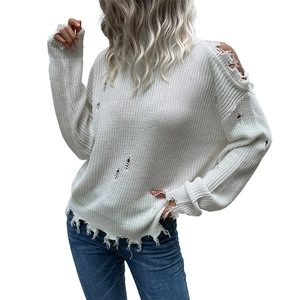 Women's white distressed oversized knit sweater with ripped details and a high neckline