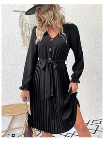 Detail of elegant black pleated V-neck dress with amber buttons and waist belt tie