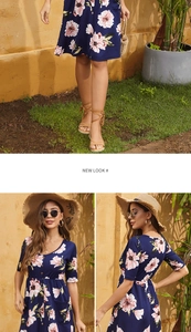 Detail view of a navy blue floral mini dress featuring a V-neck and pink flower patterns