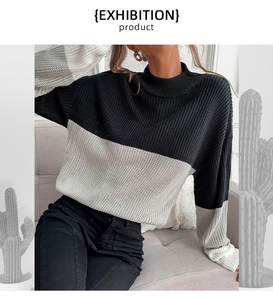 Detail of color-block knit sweater with ribbed texture and minimalist crew neck design